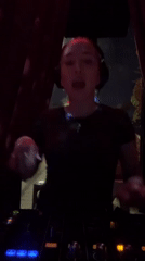 Female DJ performs at Moscow nightclub with dancing crowds