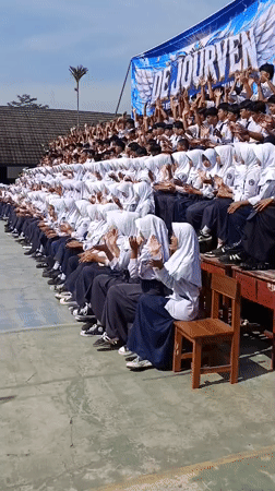 Students clapping in unison at school gathering in Tanjungsari