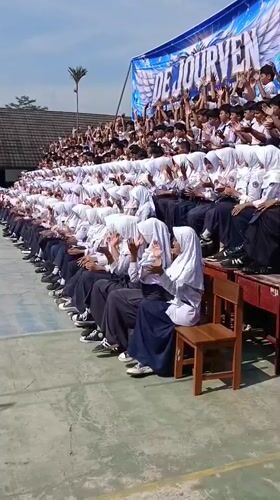 Students clapping in unison at school gathering in Tanjungsari
