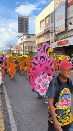 Colorful street parade with costumed dancers in Dumaguete Philippines