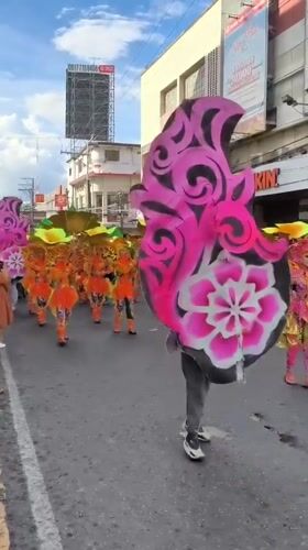 Colorful street parade with costumed dancers in Dumaguete Philippines