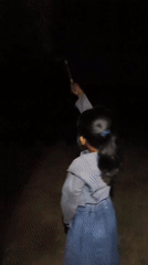 Children play with sparklers during nighttime in Saweuk, Indonesia