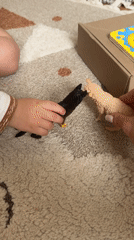 Child and adult play with toy animals in Odintsovo