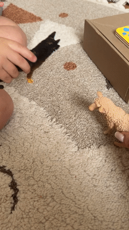 Child and adult play with toy animals in Odintsovo