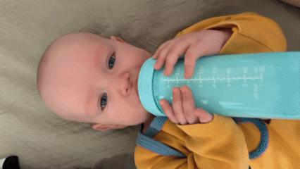 Calm home moment with a baby in a yellow onesie