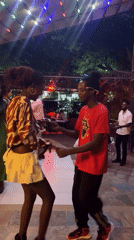 Couple dances on patio in Accra evening