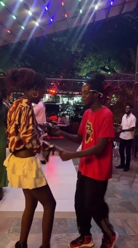 Couple dances on patio in Accra evening