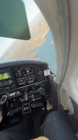 Cockpit view flying over Santa Barbara's coastal mountains and water