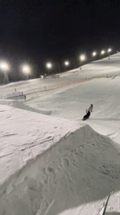 Snowboarder performs nighttime trick on illuminated Krasnoyarsk slope