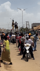 Painted crowd celebrates in streets of Bukuru, Nigeria