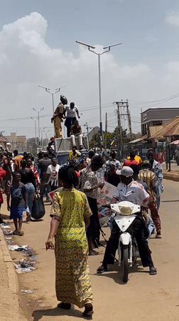 Painted crowd celebrates in streets of Bukuru, Nigeria