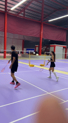 Badminton match captured on indoor court in Ko Samui