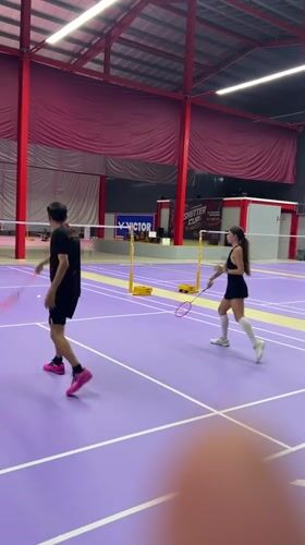 Badminton match captured on indoor court in Ko Samui