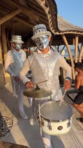 Disco ball performers and live drums at a Bali outdoor event