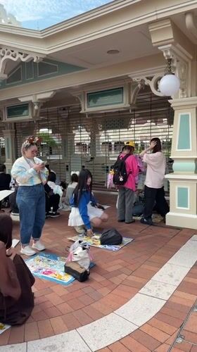 Evening crowds pack Tokyo Disneyland amid cloudy weather