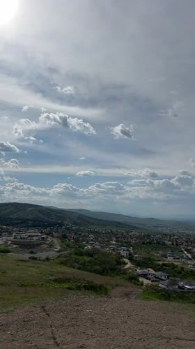 Dog walker documents hillside views in Markovo, Bulgaria