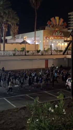Nighttime group dance performance draws dozens to Arica parking lot
