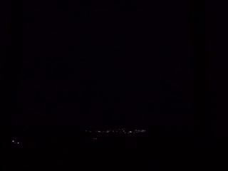 Lightning illuminates distant cityscape in nighttime Mexico footage