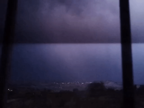 Lightning illuminates distant cityscape in nighttime Mexico footage