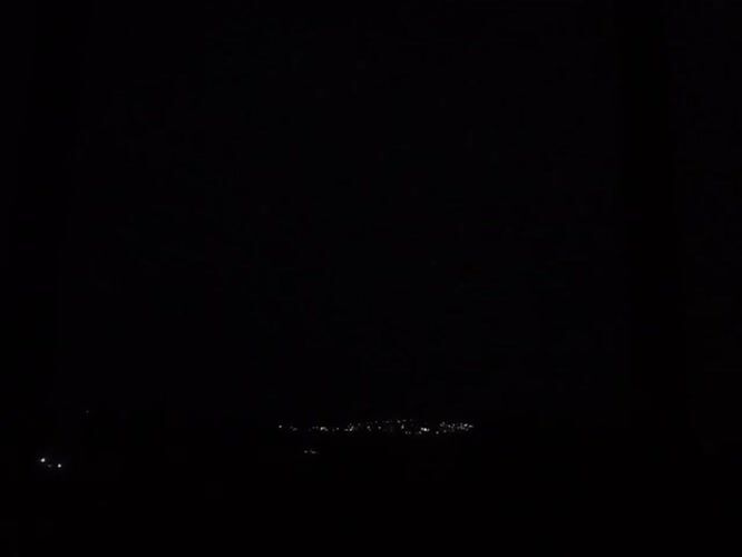 Lightning illuminates distant cityscape in nighttime Mexico footage