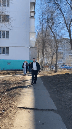 Man walks with object on path in Chaikovsky