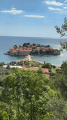 Tourists document scenic views of Sveti Stefan island resort
