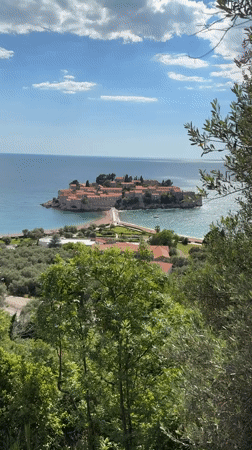 Tourists document scenic views of Sveti Stefan island resort