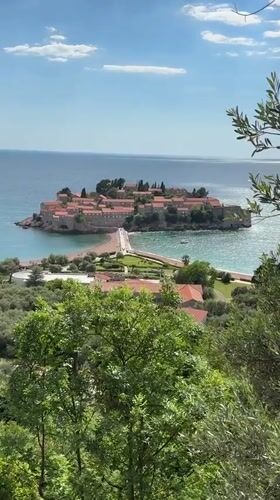 Tourists document scenic views of Sveti Stefan island resort
