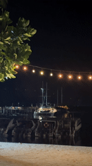 Nighttime marina scene captured from beach in Thailand