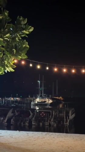 Nighttime marina scene captured from beach in Thailand