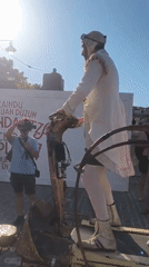 Street festival and dragon performance outside Lekeitio's stone church