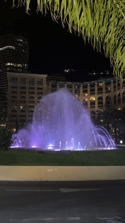 Monaco nighttime scenes feature illuminated fountains and casino district