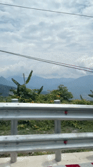 Vehicle travels mountain road in Nam Khanh Vinh, Vietnam
