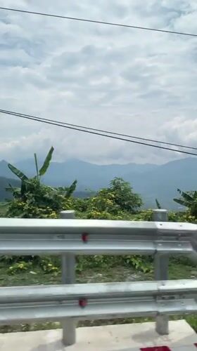 Vehicle travels mountain road in Nam Khanh Vinh, Vietnam
