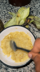 Banana mashed with spoon in bowl, Sabon Tasha