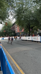 Cycling race and sports cars share a closed Vancouver street