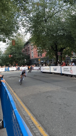 Cycling race and sports cars share a closed Vancouver street