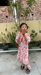 Girl dances on rooftop garden in Dhaka