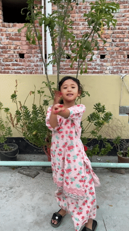 Girl dances on rooftop garden in Dhaka