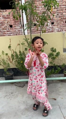 Girl dances on rooftop garden in Dhaka