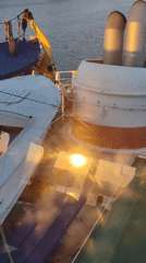 Maritime vessel and waterway sunset documented simultaneously