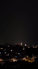 Lightning strikes over the Antwerp skyline at night