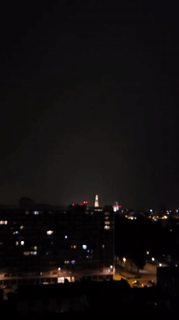 Lightning strikes over the Antwerp skyline at night