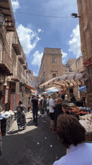 Morning market activity documented across Palermo food stalls