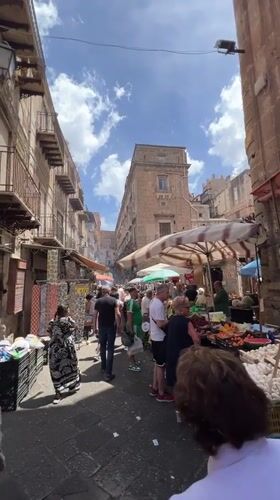 Morning market activity documented across Palermo food stalls