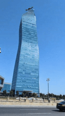 Baku's glass towers and blooming oleanders on a clear June morning