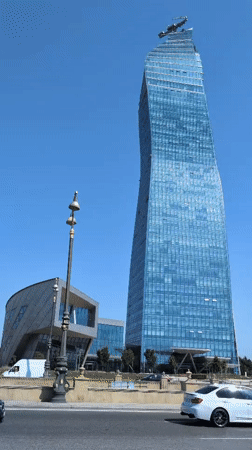 Baku's glass towers and blooming oleanders on a clear June morning