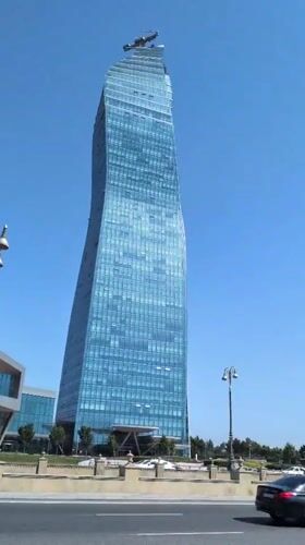 Baku's glass towers and blooming oleanders on a clear June morning