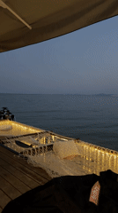 Cozy lit deck with hammock by the water in Ravda