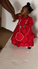 Child in red dress photographed in Jos-Bukuru, Nigeria